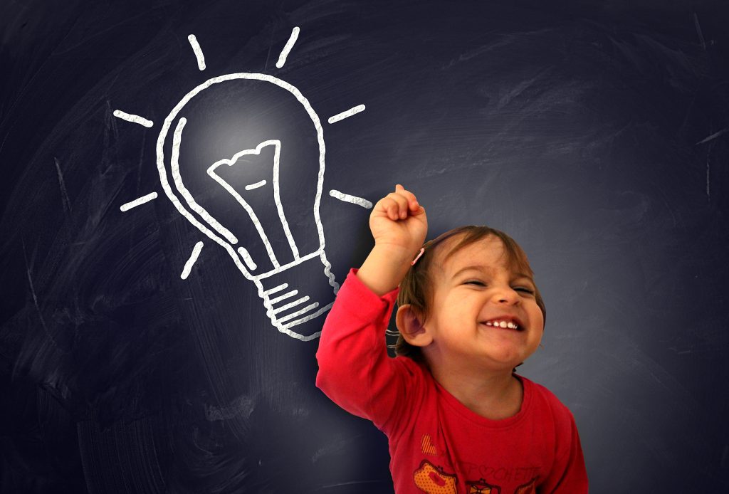 little cute girl having a good idea on the blackboard