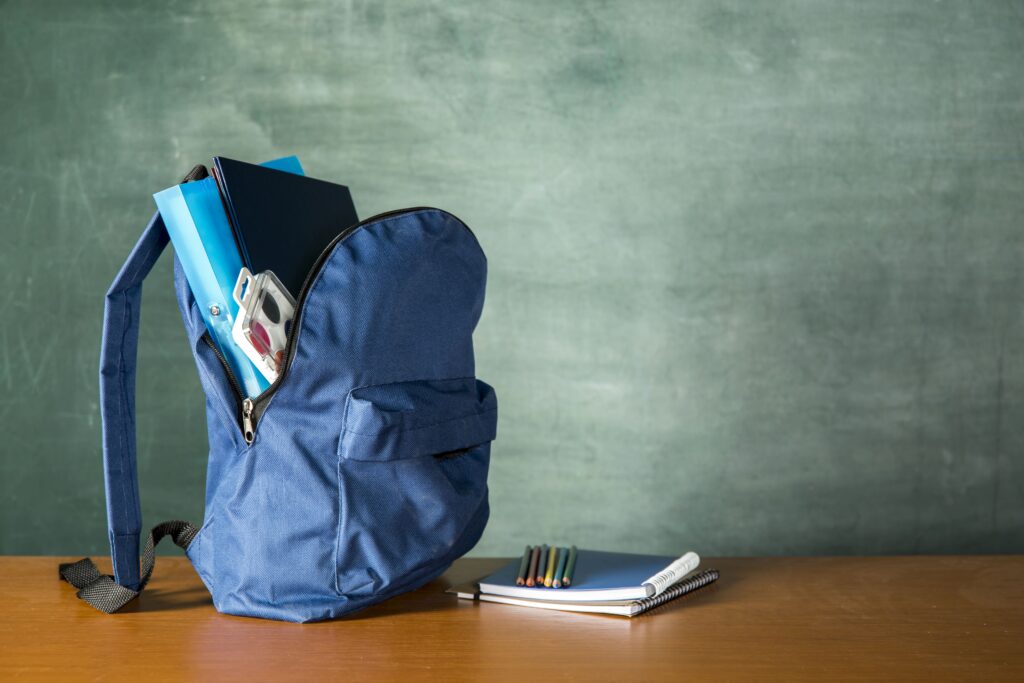 open knapsack with stationery watercolors min scaled