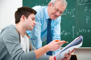 A student and teacher working together in a classroom